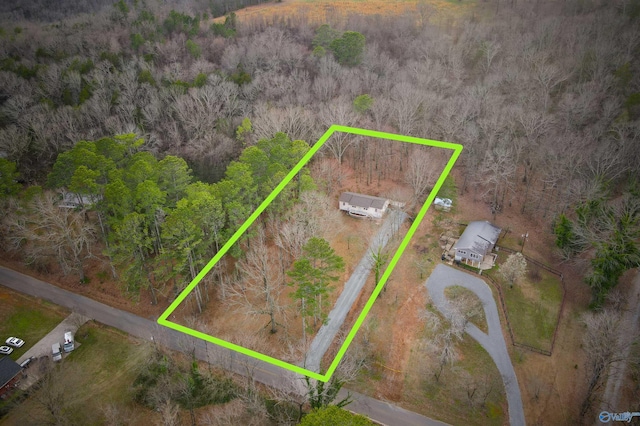 birds eye view of property featuring a wooded view