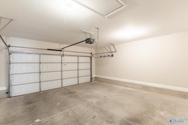 garage with a garage door opener and baseboards