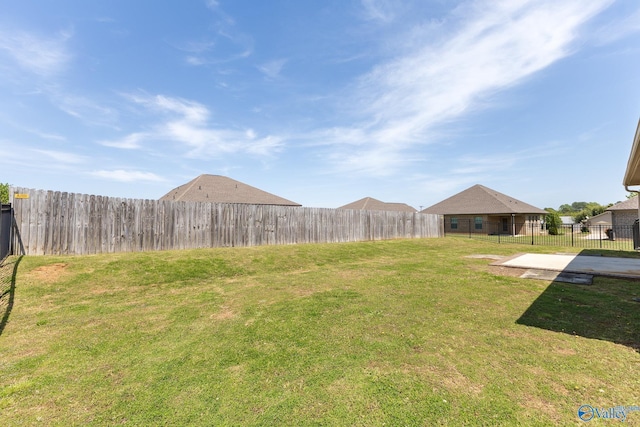 view of yard featuring a patio area and a fenced backyard