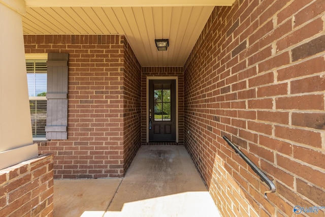 property entrance featuring brick siding