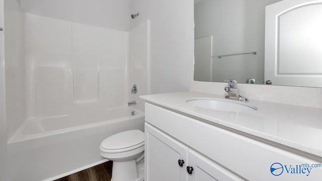 full bathroom featuring shower / tub combination, vanity, wood-type flooring, and toilet