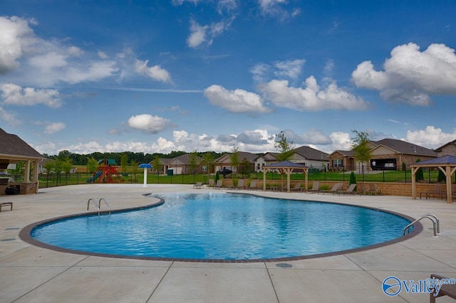 view of pool with a gazebo, a patio area, and a playground