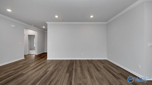 empty room featuring dark hardwood / wood-style flooring and crown molding