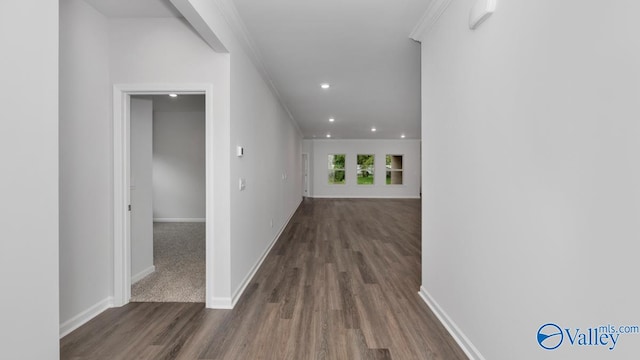 hallway with crown molding and dark hardwood / wood-style floors