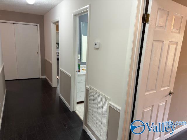 2500 Montezuma Dr, Gadsden, AL 35904 - corridor featuring visible vents and dark wood finished floors