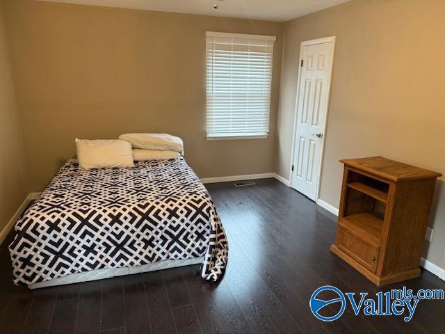 2500 Montezuma Dr, Gadsden, AL 35904 - bedroom with baseboards and dark wood-style flooring