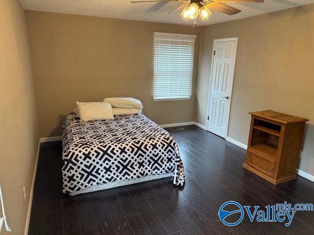 2500 Montezuma Dr, Gadsden, AL 35904 - bedroom with dark wood finished floors, a ceiling fan, and baseboards