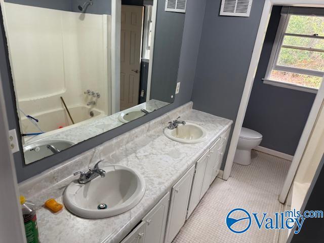 2500 Montezuma Dr, Gadsden, AL 35904 - bathroom with toilet, visible vents, a sink, and tile patterned floors