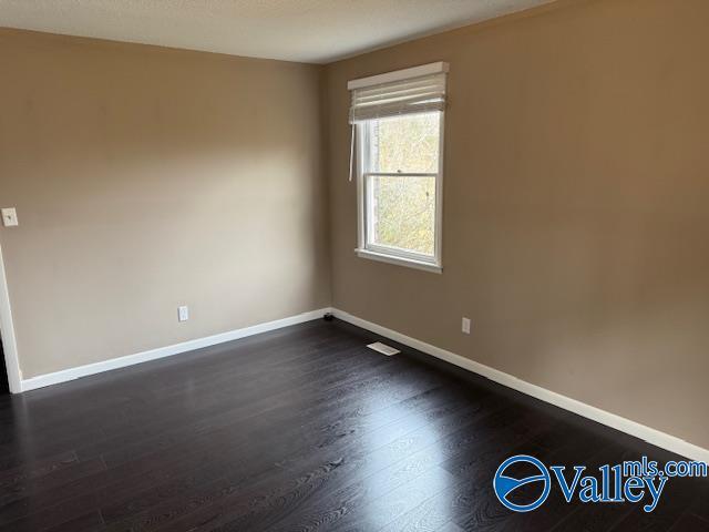 2500 Montezuma Dr, Gadsden, AL 35904 - spare room featuring dark wood-style floors and baseboards