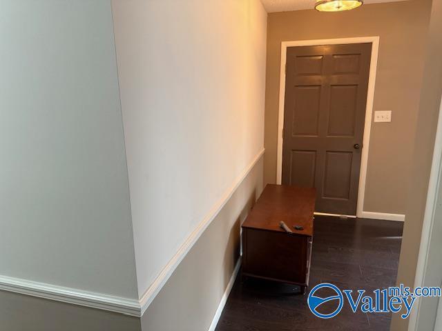 2500 Montezuma Dr, Gadsden, AL 35904 - hallway featuring dark wood-style floors and baseboards
