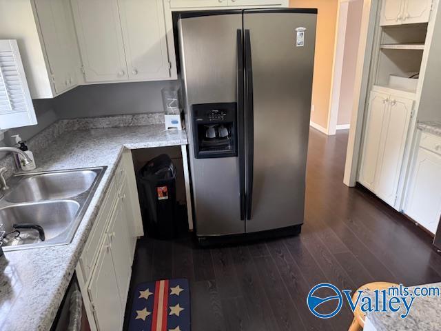 2500 Montezuma Dr, Gadsden, AL 35904 - kitchen featuring stainless steel refrigerator with ice dispenser, dark wood-type flooring, white cabinets, a sink, and light stone countertops