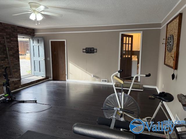 2500 Montezuma Dr, Gadsden, AL 35904 - exercise room with a ceiling fan, a textured ceiling, baseboards, and wood finished floors