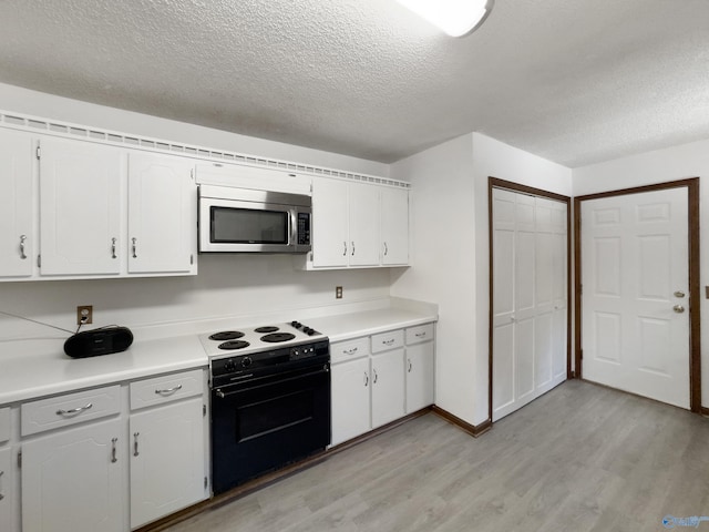 kitchen featuring black range with electric stovetop, a textured ceiling, light hardwood / wood-style floors, and white cabinetry