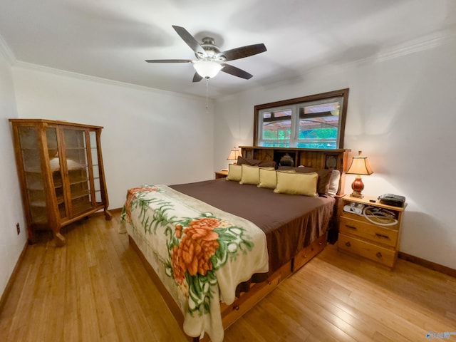 bedroom featuring ornamental molding, ceiling fan, and light hardwood / wood-style flooring