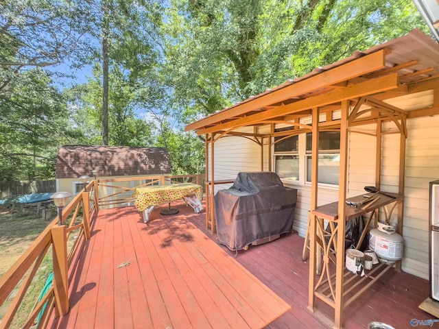 deck featuring a grill and a shed