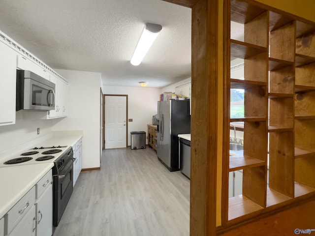 kitchen featuring light wood-type flooring, a textured ceiling, white cabinetry, and stainless steel appliances