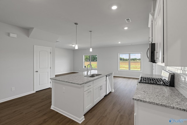 kitchen featuring sink, stainless steel appliances, white cabinetry, a center island with sink, and pendant lighting