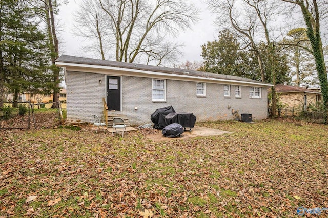 2217 Linde St, Huntsville, AL 35810 - back of property featuring brick siding, a fenced backyard, central air condition unit, and entry steps