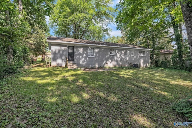 2217 Linde St, Huntsville, AL 35810 - rear view of house featuring entry steps, a lawn, and brick siding