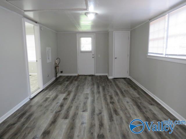 foyer entrance featuring baseboards and wood finished floors