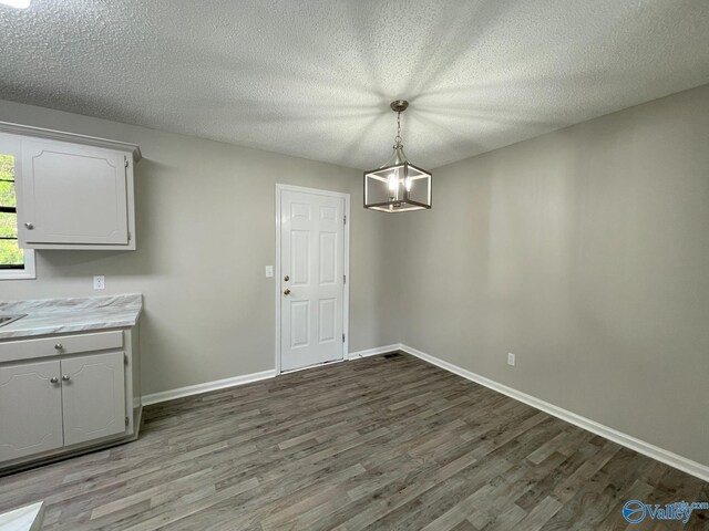 160 Guy Wilson Rd, Hazel Green, AL 35750 - unfurnished dining area with baseboards, wood finished floors, and a textured ceiling