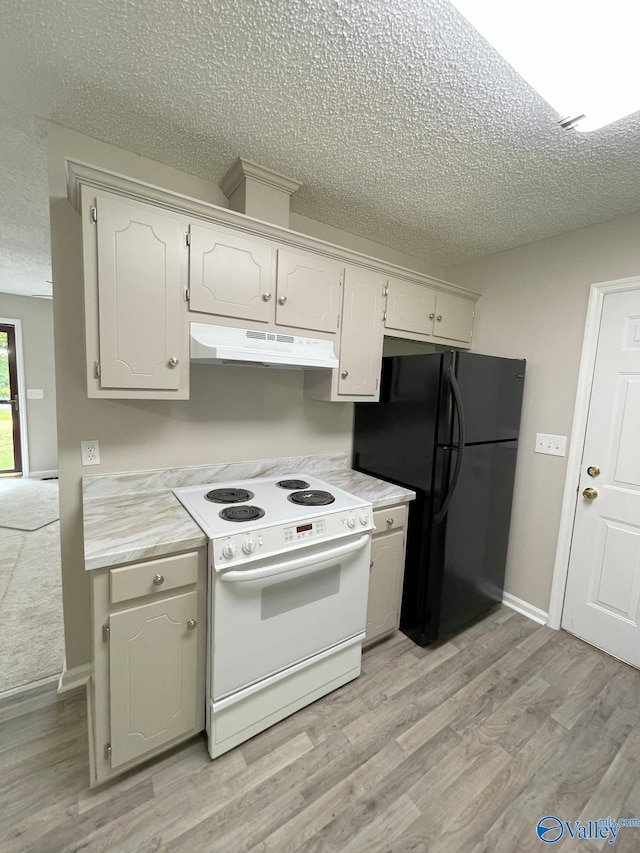 160 Guy Wilson Rd, Hazel Green, AL 35750 - kitchen with under cabinet range hood, electric stove, a textured ceiling, and freestanding refrigerator