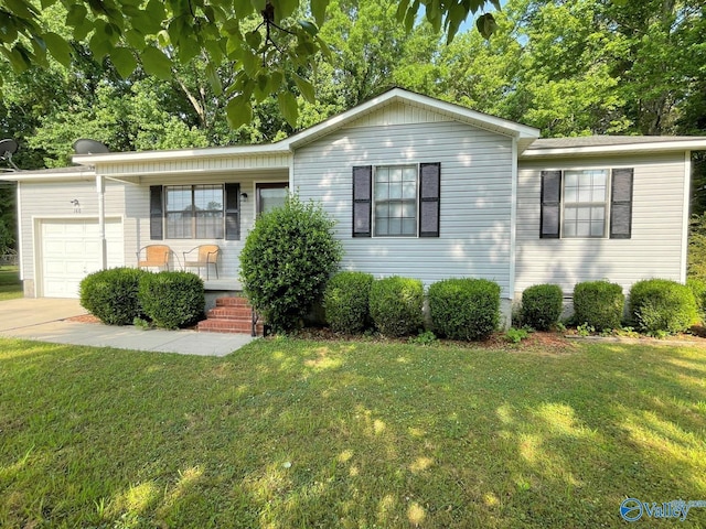 160 Guy Wilson Rd, Hazel Green, AL 35750 - view of front facade featuring a front lawn, a garage, driveway, and covered porch