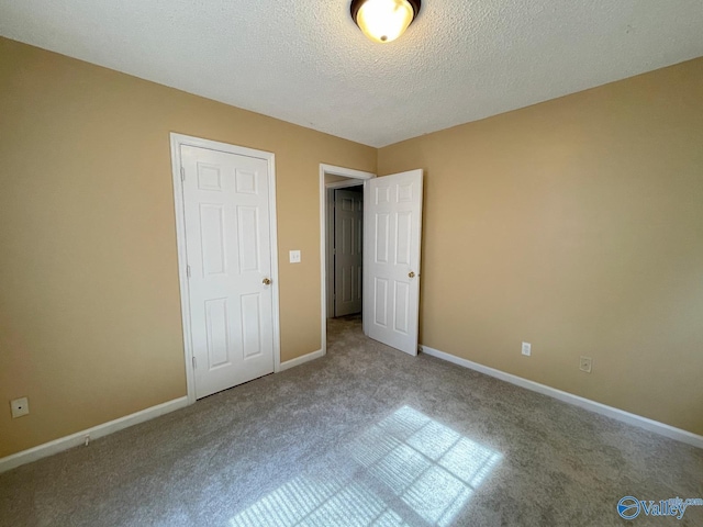 160 Guy Wilson Rd, Hazel Green, AL 35750 - unfurnished bedroom featuring carpet, baseboards, and a textured ceiling