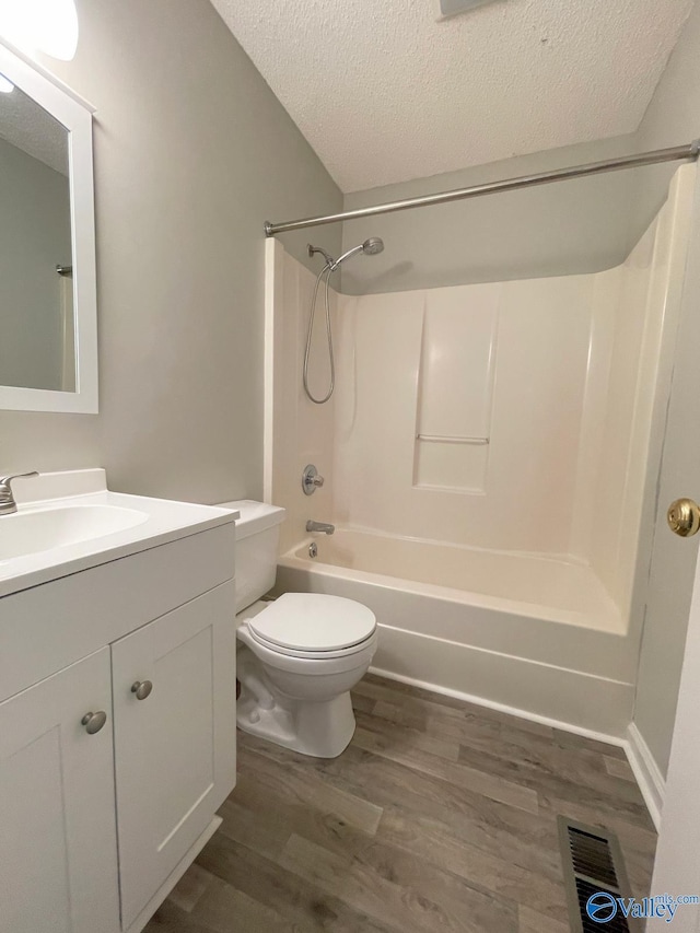 160 Guy Wilson Rd, Hazel Green, AL 35750 - full bath featuring visible vents,  shower combination, a textured ceiling, vanity, and wood finished floors