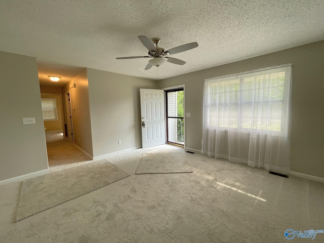 160 Guy Wilson Rd, Hazel Green, AL 35750 - carpeted spare room featuring visible vents, baseboards, a ceiling fan, and a textured ceiling