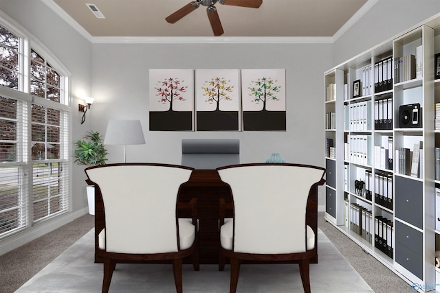 carpeted dining room featuring ceiling fan and ornamental molding