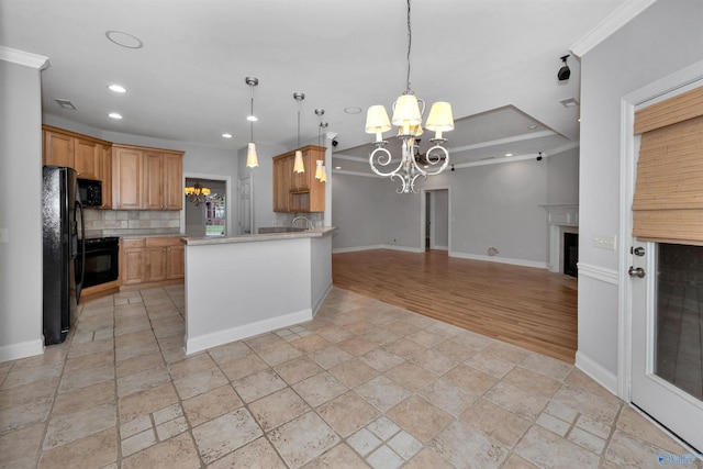 kitchen featuring ornamental molding, kitchen peninsula, a chandelier, black appliances, and light wood-type flooring