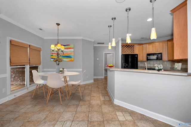 kitchen featuring tasteful backsplash, hanging light fixtures, ornamental molding, and black appliances