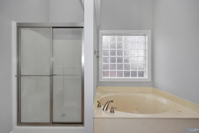 bathroom with plenty of natural light and plus walk in shower