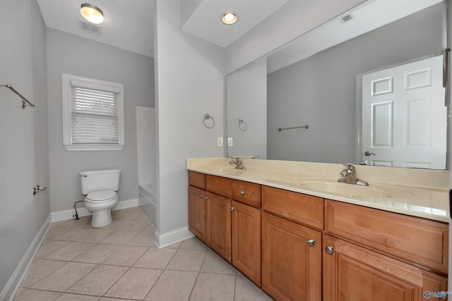 bathroom featuring tile patterned floors, vanity, toilet, and a washtub