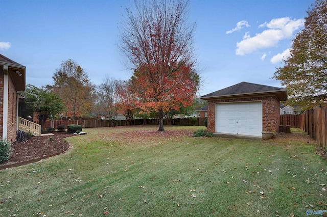 view of yard featuring an outdoor structure and a garage