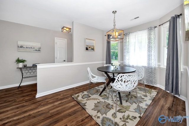 1503 Cedarwood Cir, Huntsville, AL 35803 - dining space with wood finished floors, a chandelier, plenty of natural light, and baseboards