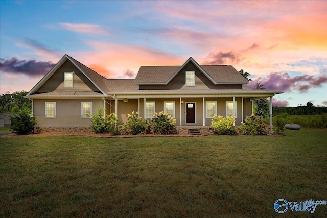 view of front facade with a porch, a front lawn, and stucco siding