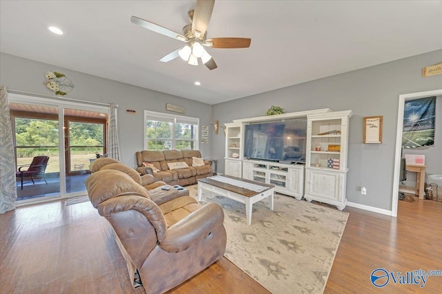 living area with recessed lighting, wood finished floors, a ceiling fan, and baseboards