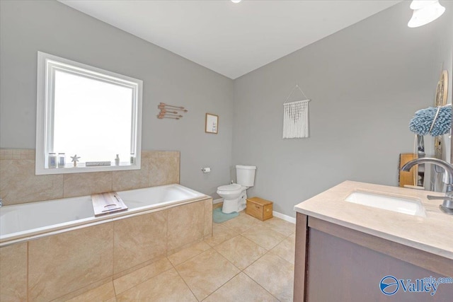full bathroom with baseboards, toilet, tile patterned flooring, vanity, and a bath