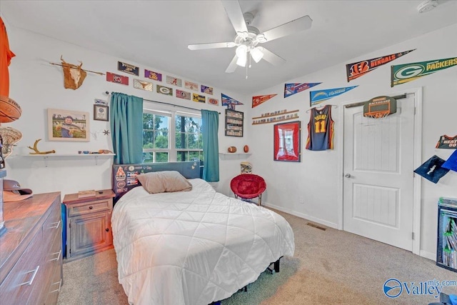 carpeted bedroom featuring ceiling fan, visible vents, and baseboards
