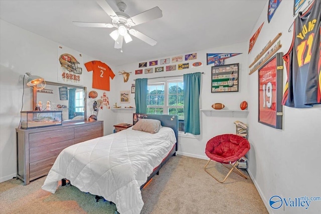 carpeted bedroom with ceiling fan, multiple windows, and baseboards