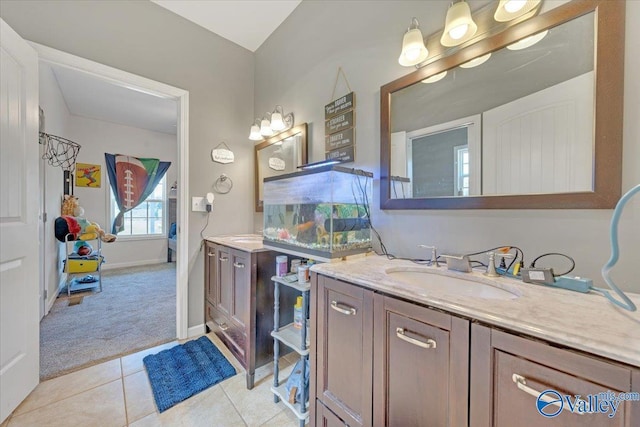 bathroom featuring vanity, baseboards, and tile patterned floors