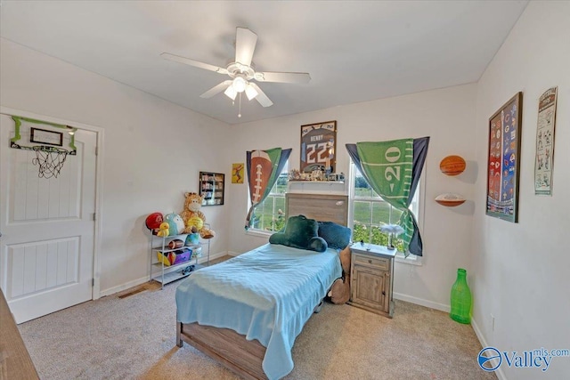 bedroom featuring baseboards, ceiling fan, and light colored carpet