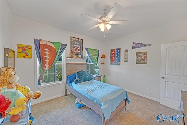 bedroom with ceiling fan, baseboards, and carpet flooring