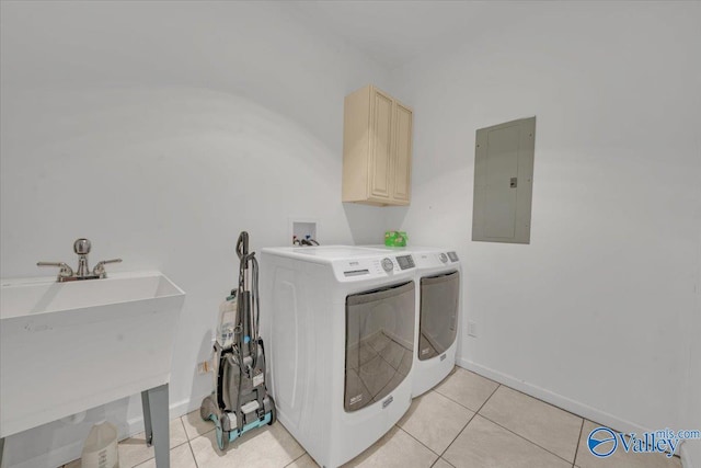 clothes washing area featuring cabinet space, light tile patterned flooring, a sink, separate washer and dryer, and electric panel