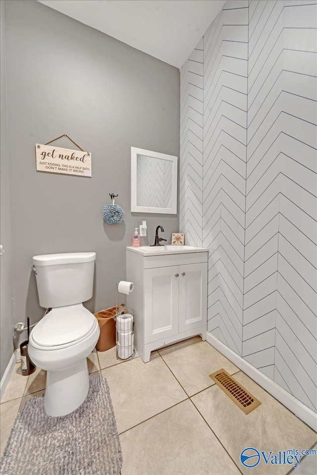 bathroom featuring toilet, vanity, visible vents, and tile patterned floors