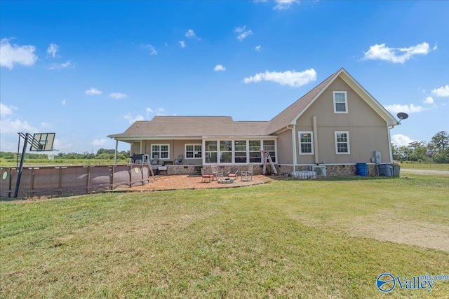 rear view of property featuring a patio area and a yard