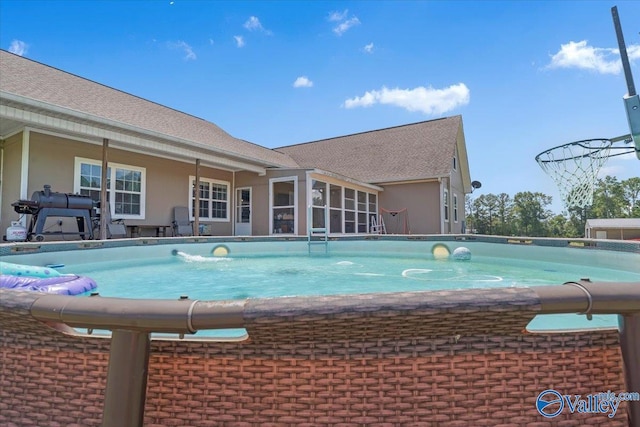 outdoor pool with a sunroom