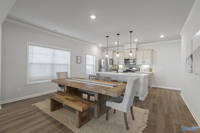 dining room featuring sink, crown molding, and dark wood-type flooring